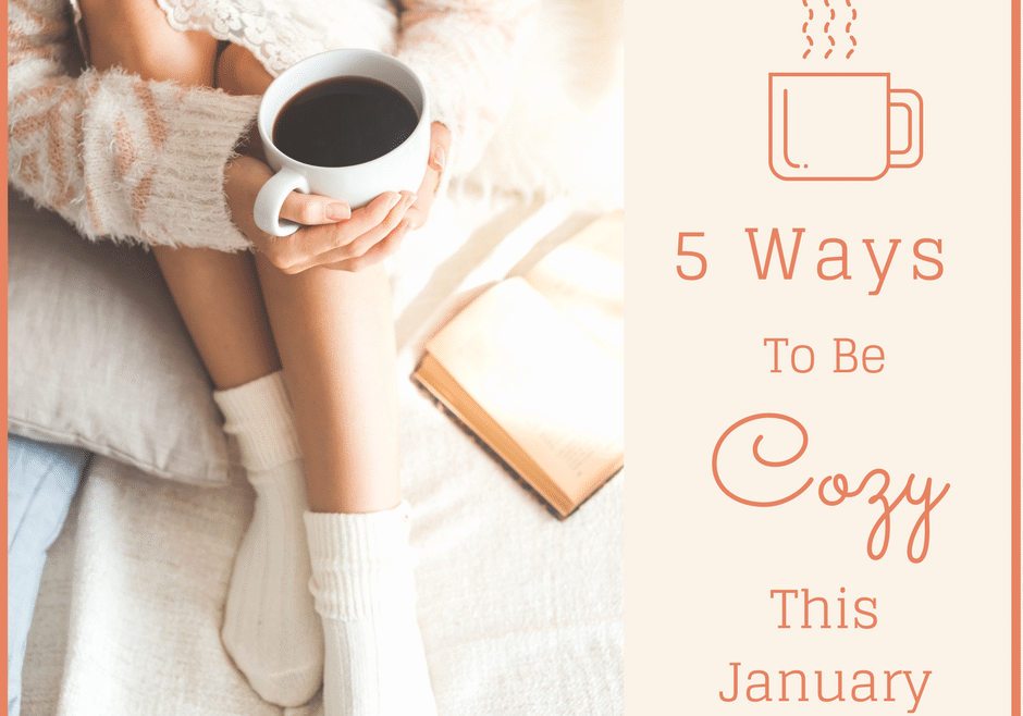 A cozy person in warm socks holds a mug of coffee while sitting with a book; text reads "5 Ways To Be Cozy This January" with a coffee cup icon.